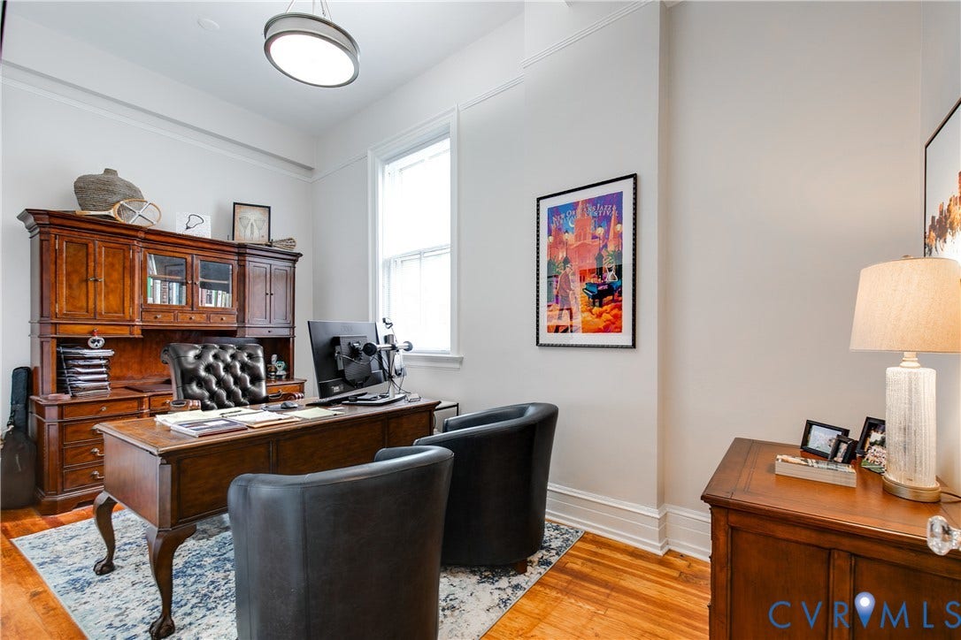 2800 Patterson Avenue, Richmond, VA 23221 Room featuring high ceilings, tall windows with millwork casing, polished wood-finish flooring, and a modern circular ceiling-mounted light fixture