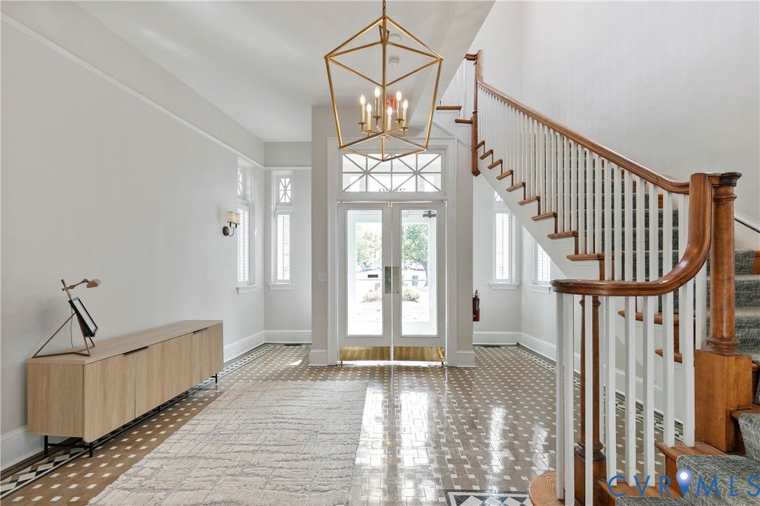 2800 Patterson Avenue, Richmond, VA 23221 Grand entrance featuring a double-door entryway with transom windows, decorative geometric chandelier, staircase with natural wood handrail, and intricate patterned tile flooring