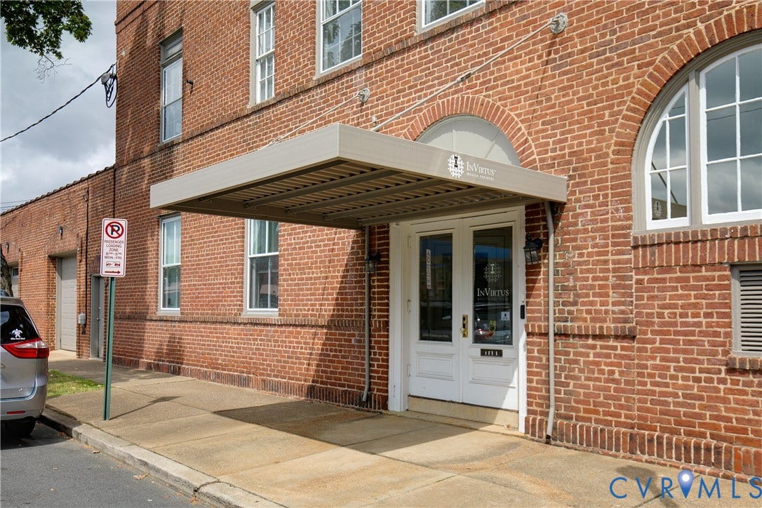2800 Patterson Avenue, Richmond, VA 23221 Exterior facade featuring classic red brick masonry, double glass-paneled entry doors, arched window detailing, and a modern metal canopy