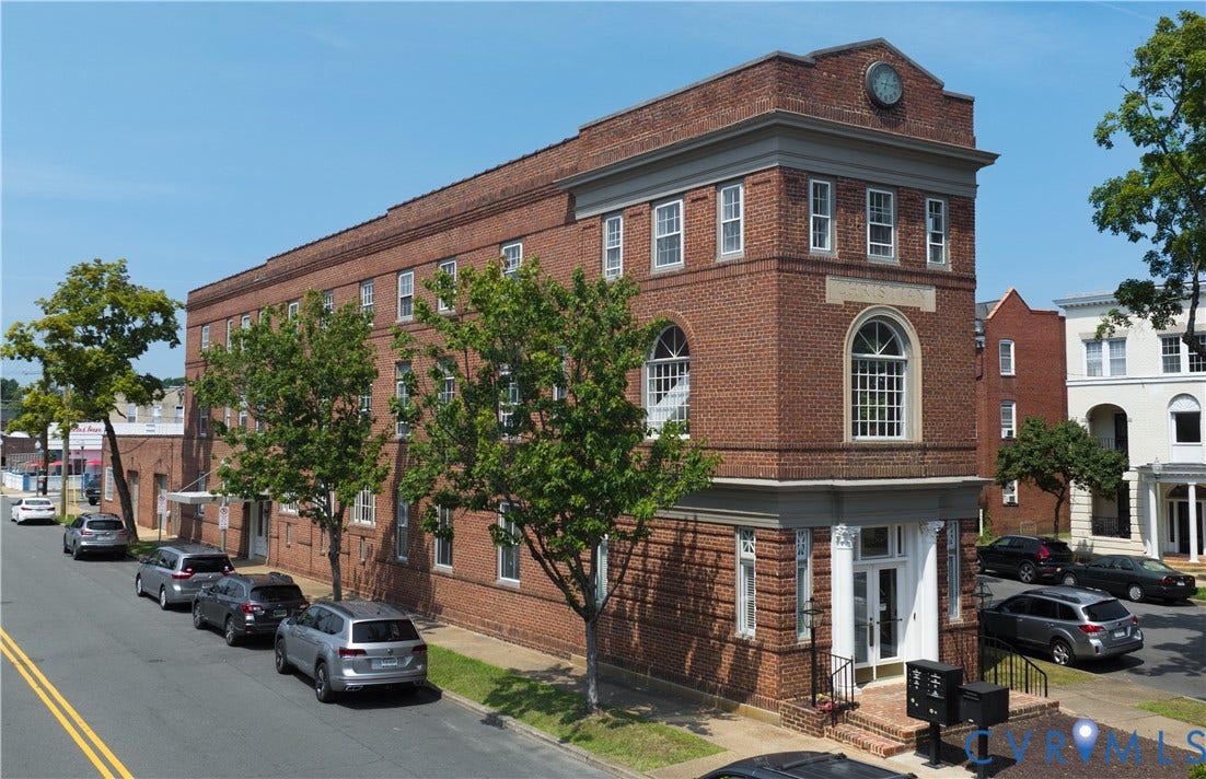 2800 Patterson Avenue, Richmond, VA 23221 Three-story brick exterior featuring a classical pediment, decorative cornice, arched masonry window detailing, and a columned entrance