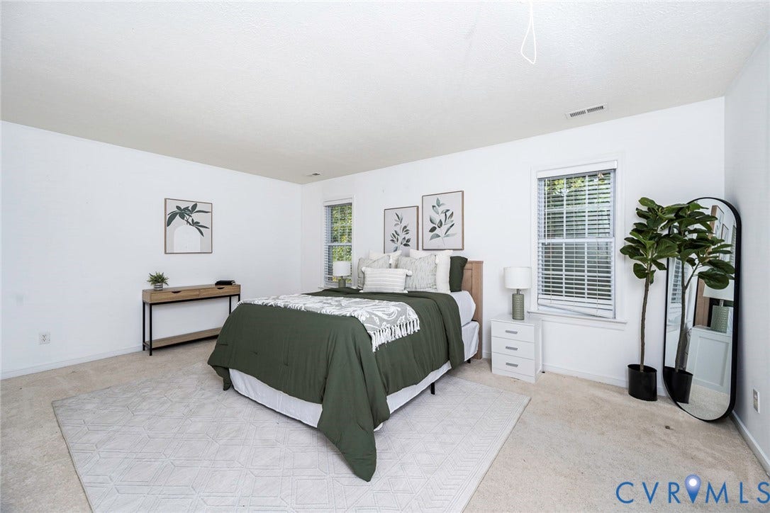 2408 Swartwout Avenue, Woodland Hills, Henrico, VA 23228 Neutral-toned interior space featuring light-colored wall-to-wall carpeting, dual double-pane windows, and high-contrast white wall finishes