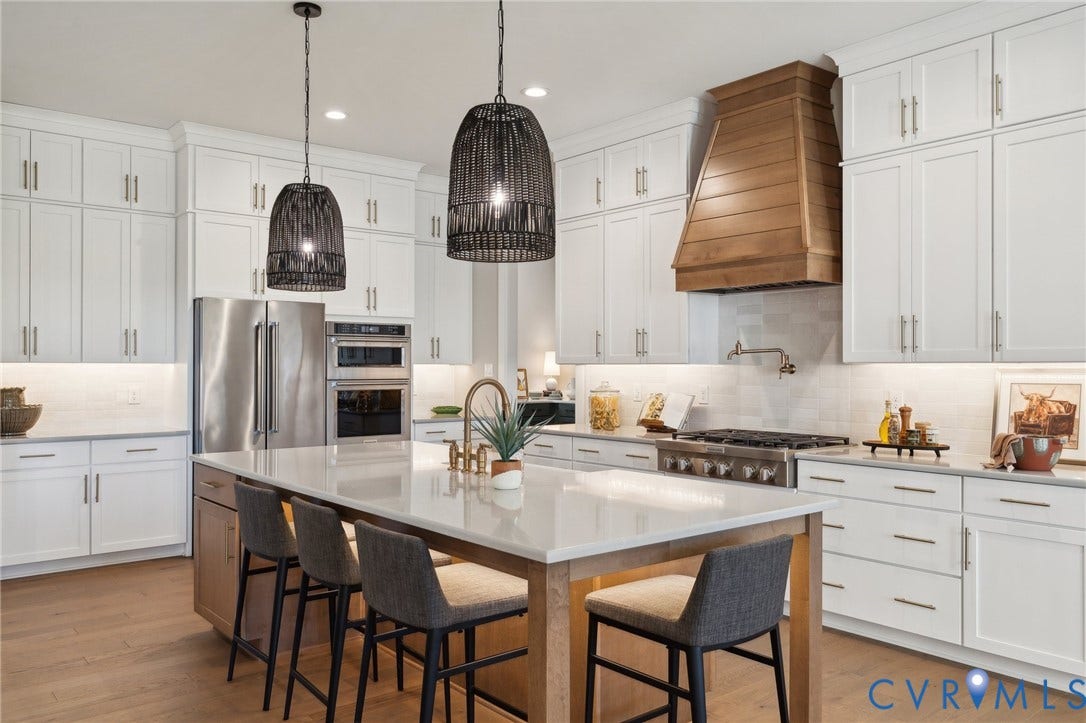 18128 Dogwood Trail Way, Rockville, VA 23146 Kitchen featuring white shaker cabinetry, an expansive center island with a stone countertop, a custom wood range hood, stainless steel appliances, and wood-finish flooring