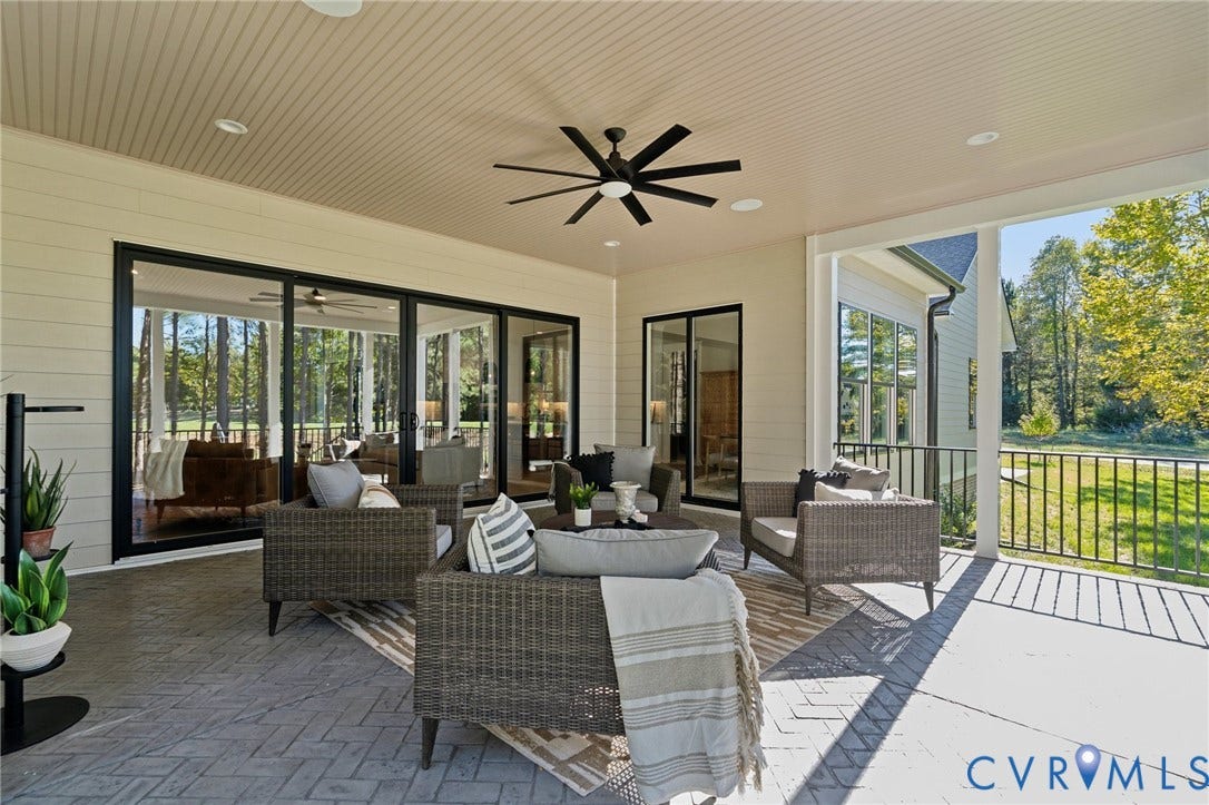 18128 Dogwood Trail Way, Rockville, VA 23146 Covered patio featuring a herringbone-patterned stone floor, recessed lighting, matte black ceiling fan, horizontal lap siding, and sliding glass panel doors