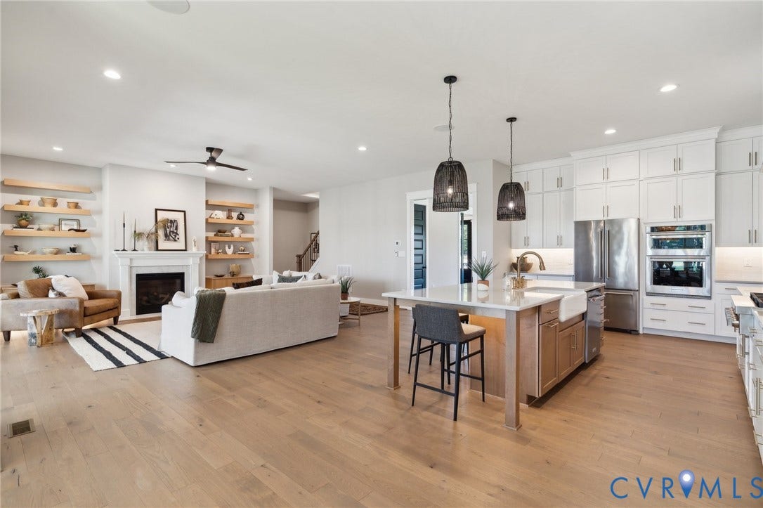 18128 Dogwood Trail Way, Rockville, VA 23146 Kitchen featuring an oversized island with an apron-front sink, white cabinetry, integrated stainless steel appliances, and wood-finish flooring