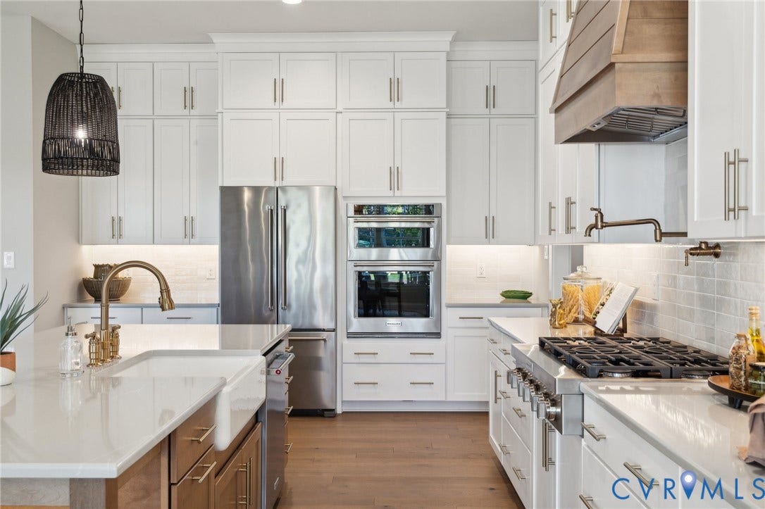 18128 Dogwood Trail Way, Rockville, VA 23146 Kitchen featuring white Shaker-style cabinetry, a farmhouse-style apron sink, quartz countertops, a stainless steel double wall oven, and a wood-finish range hood