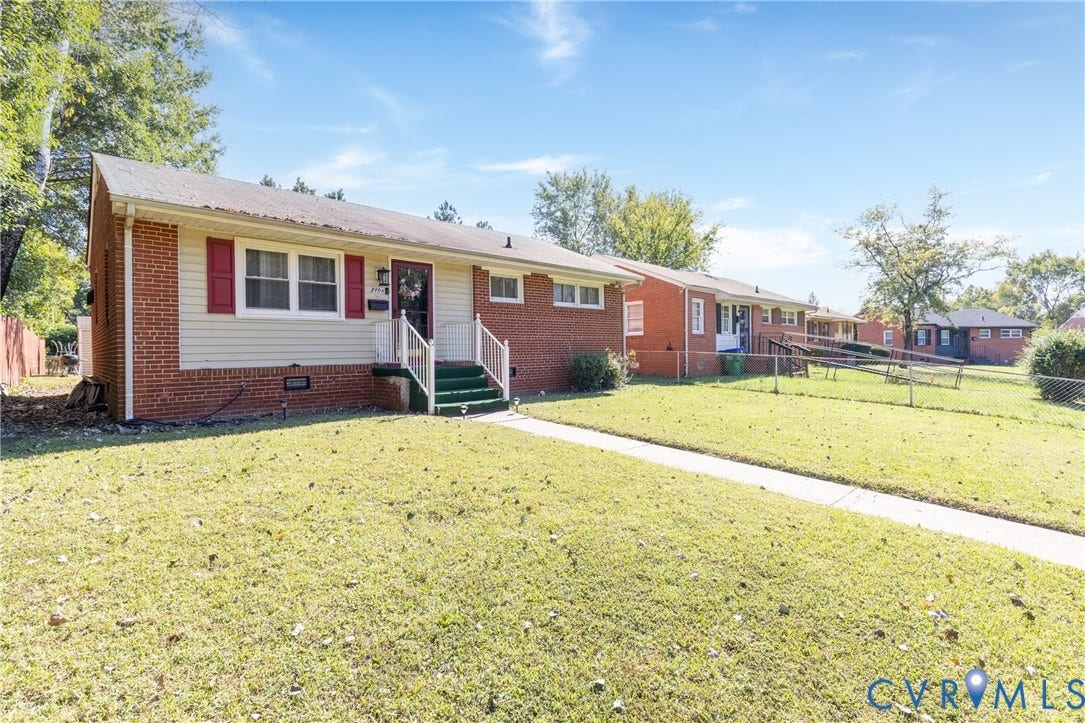 2108 Ridgemont Road, Richmond, VA 23224 Single-story brick and siding exterior featuring red shutters, a metal front door awning, and a paved walkway
