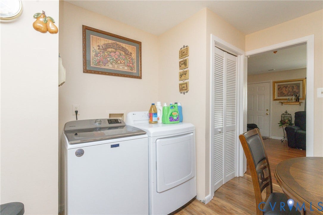 2108 Ridgemont Road, Richmond, VA 23224 Laundry area featuring wood-finish flooring and a white louvered-door closet