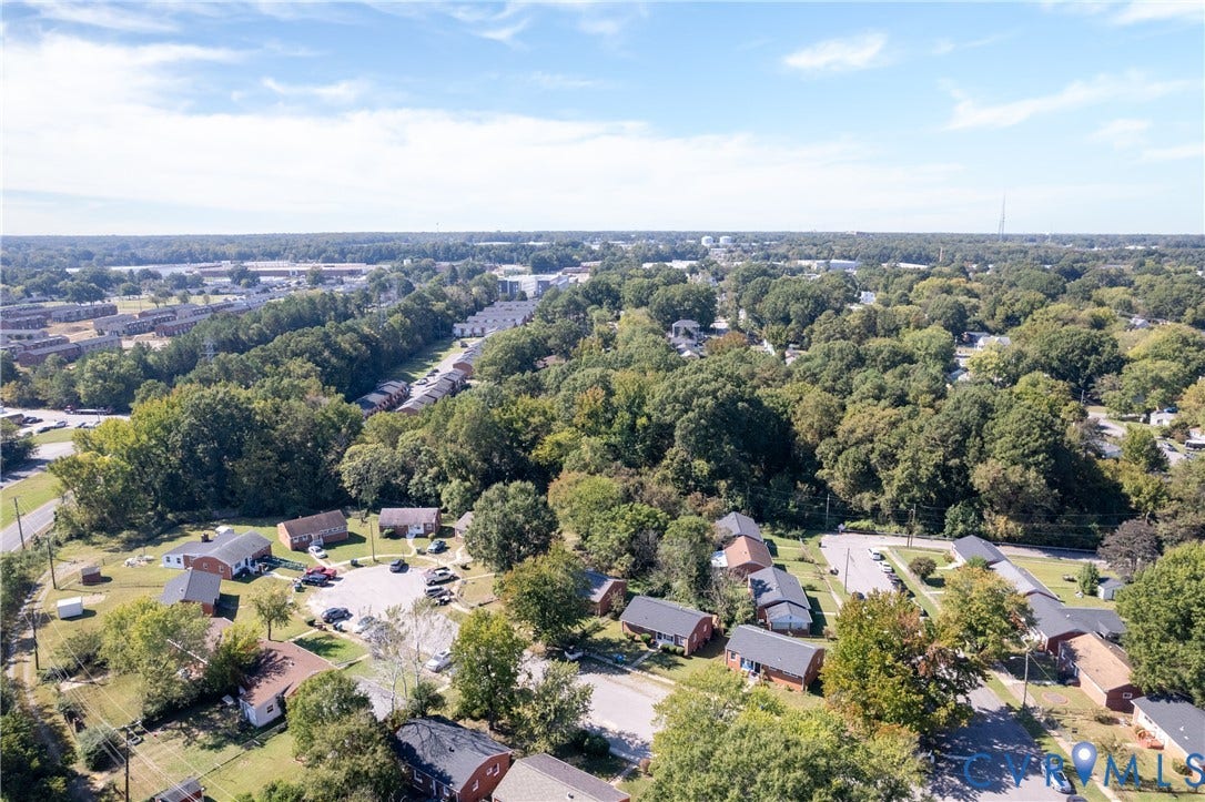 2108 Ridgemont Road, Richmond, VA 23224 Aerial perspective of a residential cluster featuring brick-exterior structures, cul-de-sac street layout, mature tree canopy, and paved parking areas