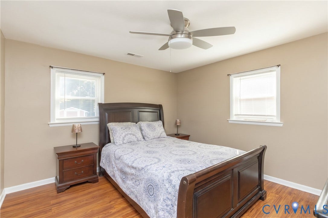 2108 Ridgemont Road, Richmond, VA 23224 Room featuring wood-finish flooring, two dual-pane windows, and a ceiling fan with integrated lighting