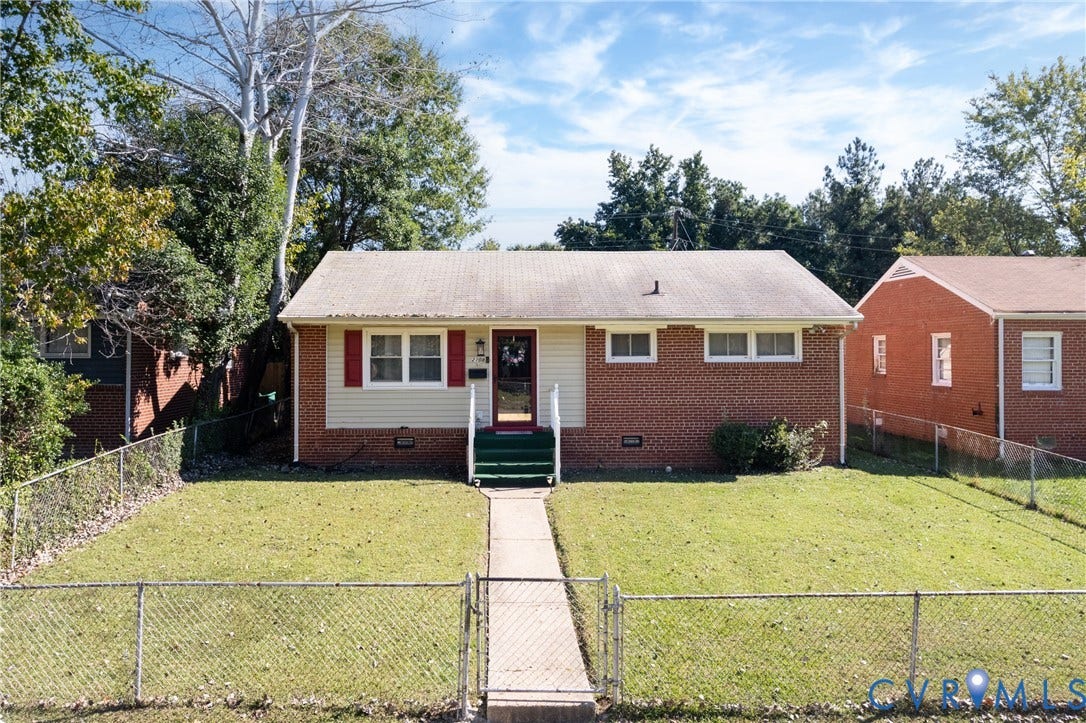 2108 Ridgemont Road, Richmond, VA 23224 Single-story brick and siding exterior featuring red shutters, a paved front walkway, and a fenced yard