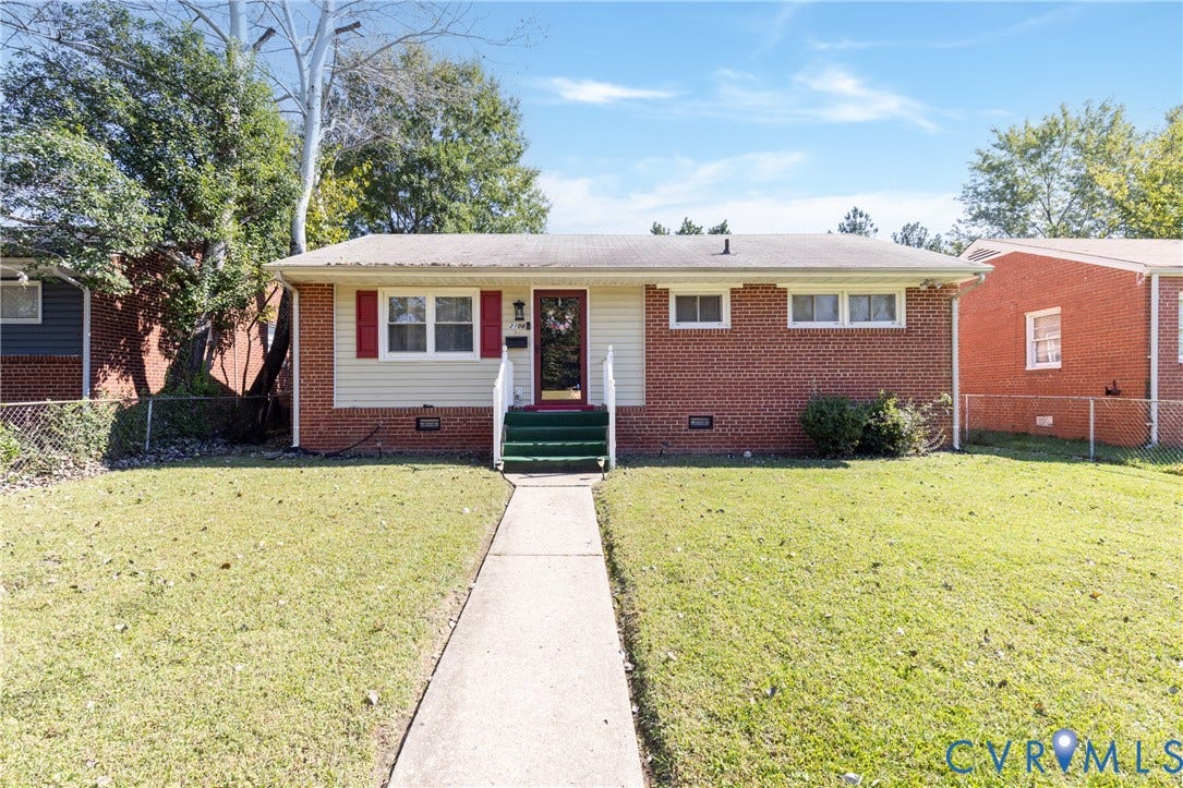 2108 Ridgemont Road, Richmond, VA 23224 Single-story exterior featuring red brick masonry, light-toned horizontal siding, decorative shutters, and a concrete walkway leading to the entrance
