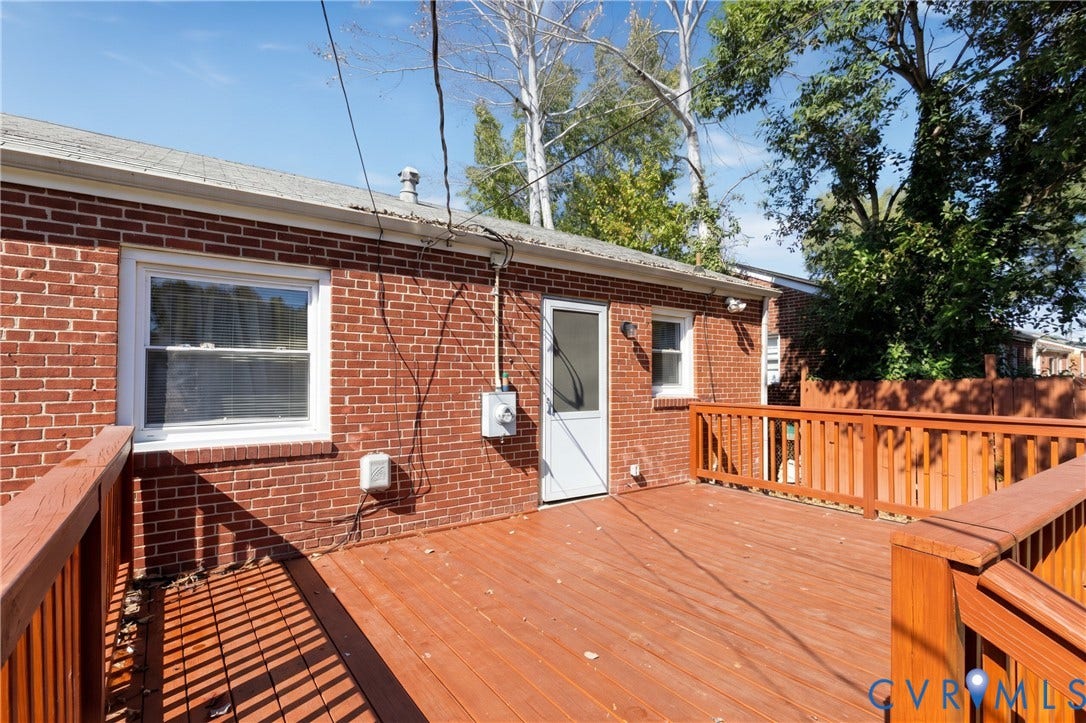 2108 Ridgemont Road, Richmond, VA 23224 Exterior brick facade featuring a raised wooden deck with railings