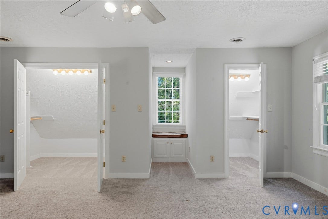 7270 Crossing Oaks Trail, Mechanicsville, VA 23111 Carpeted room featuring dual reach-in closets, a recessed window nook with built-in cabinetry, and a ceiling fan with light kit