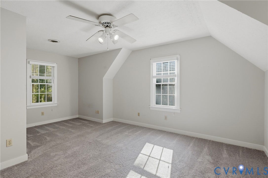 7270 Crossing Oaks Trail, Mechanicsville, VA 23111 Interior room featuring wall-to-wall carpeting, vaulted ceilings, multi-pane windows, and a ceiling fan with integrated lighting
