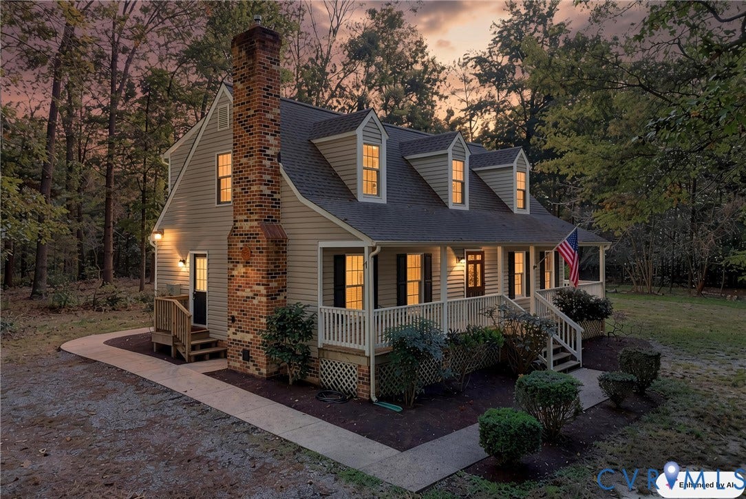 7270 Crossing Oaks Trail, Mechanicsville, VA 23111 Exterior featuring horizontal siding, a prominent brick chimney, three dormer windows, a covered front porch with railings, and a concrete walkway
