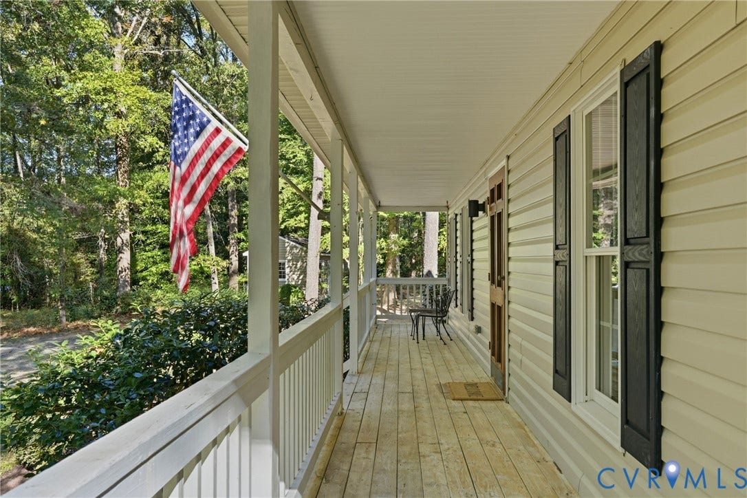 7270 Crossing Oaks Trail, Mechanicsville, VA 23111 Covered porch featuring light-toned wood flooring, white railings, siding exterior, and black window shutters