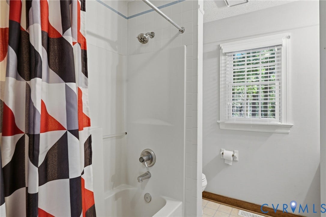 7270 Crossing Oaks Trail, Mechanicsville, VA 23111 Shower and bathtub combination featuring white wall surround, chrome fixtures, and a window with white horizontal blinds