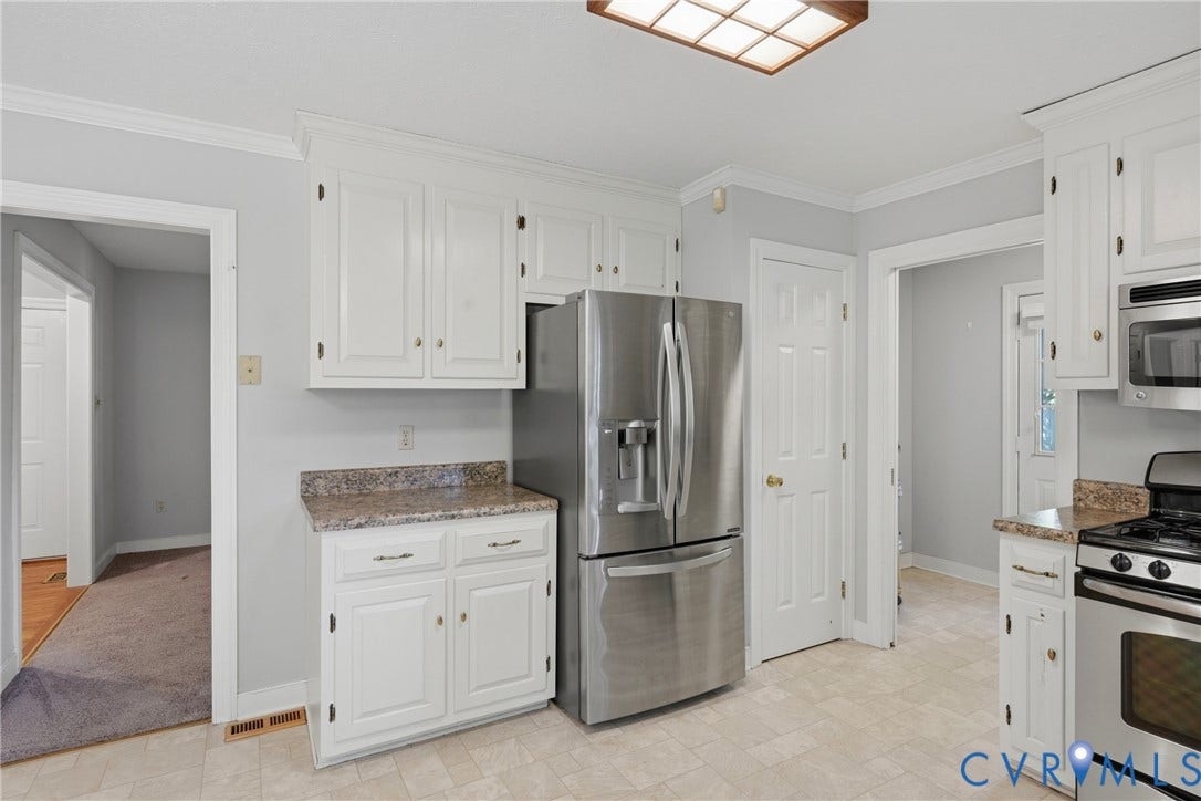 7270 Crossing Oaks Trail, Mechanicsville, VA 23111 Kitchen featuring white cabinetry, stone-finish countertops, stainless steel refrigerator, built-in microwave, and tile flooring