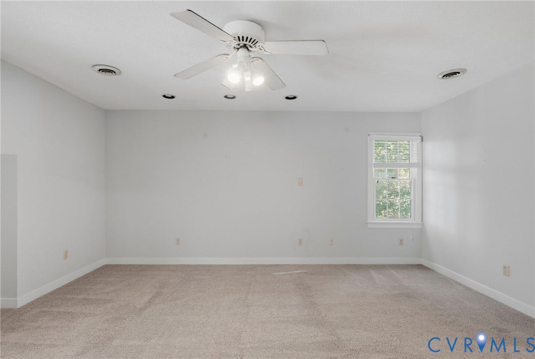 7270 Crossing Oaks Trail, Mechanicsville, VA 23111 Neutral-toned interior space featuring wall-to-wall carpeting, recessed lighting, a white ceiling fan with integrated light fixture, and a single window with muntin detailing