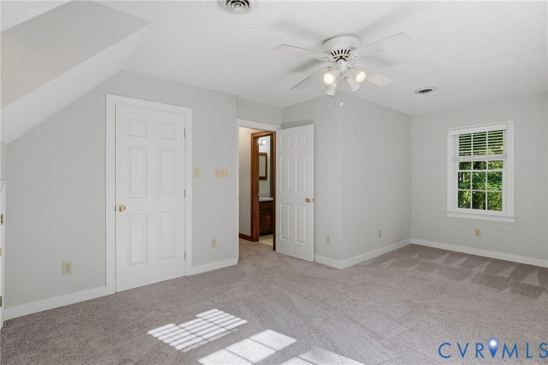 7270 Crossing Oaks Trail, Mechanicsville, VA 23111 Neutral-toned room with plush carpeting, ceiling fan with integrated lighting, multi-pane window with grid inserts, and six-panel interior doors