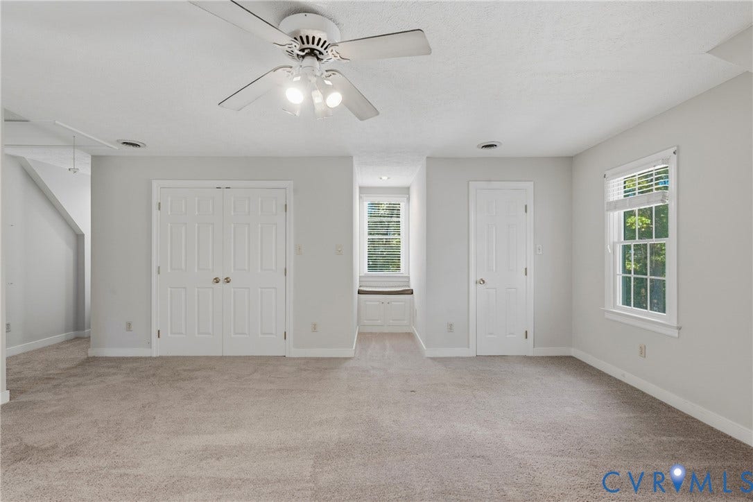 7270 Crossing Oaks Trail, Mechanicsville, VA 23111 Room featuring carpeted flooring, a ceiling fan with integrated lighting, dual-panel closet doors, a single-panel interior door, and a built-in window seat with under-bench cabinetry