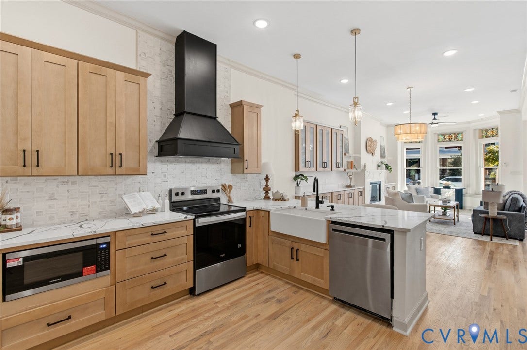 3104 E Broad Street, Richmond, VA 23223 Kitchen featuring light-finish cabinetry, stone-surface countertops, a farmhouse-style apron sink, a matte black range hood, and wood-finish flooring