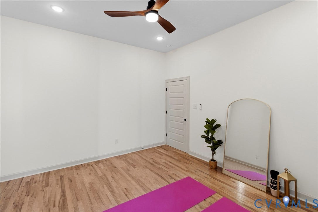 3104 E Broad Street, Richmond, VA 23223 Room featuring high ceilings, wood-finish flooring, recessed lighting, and a modern ceiling fan with integrated lighting
