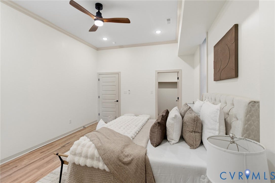 3104 E Broad Street, Richmond, VA 23223 Interior room featuring wood-finish flooring, tray ceilings, recessed lighting, and a modern three-blade ceiling fan with integrated lighting