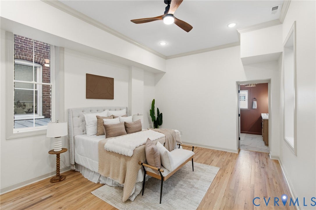 3104 E Broad Street, Richmond, VA 23223 Neutral-toned interior featuring wood-finish flooring, recessed lighting, crown molding, and a modern ceiling fan with integrated lighting