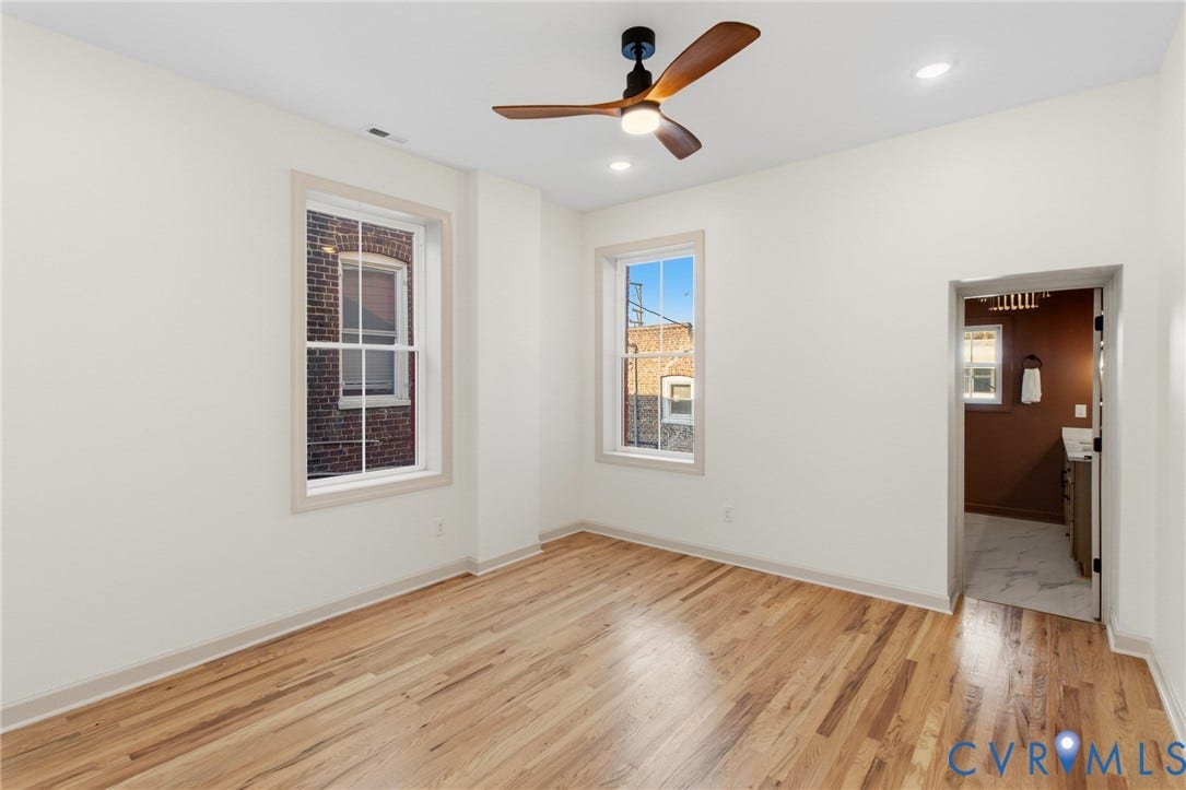3104 E Broad Street, Richmond, VA 23223 Interior space featuring wood-finish flooring, two sash windows with neutral trim, recessed lighting, and a modern three-blade ceiling fan