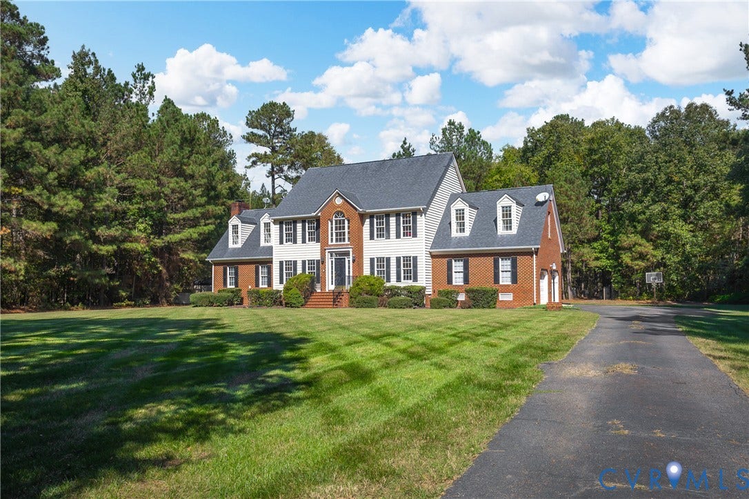11400 County Drive, Prince George, VA 23842 Two-story residence featuring a brick and siding exterior, multi-gabled roofline, and a paved driveway