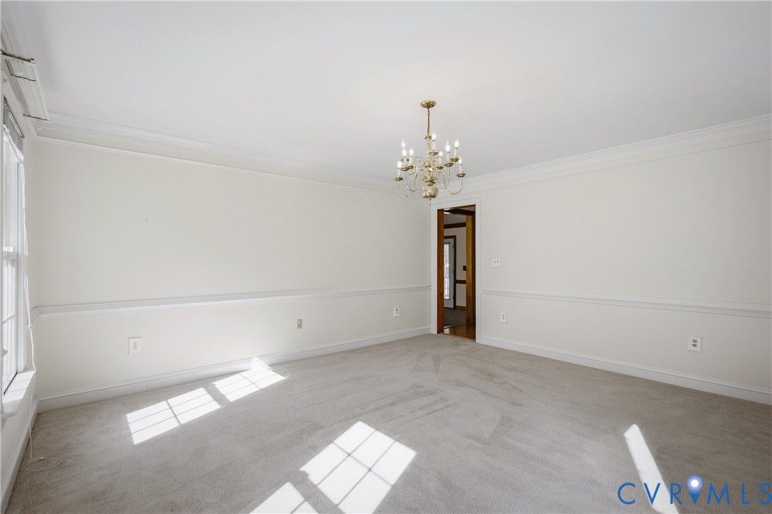 11400 County Drive, Prince George, VA 23842 Room featuring neutral carpeting, crown molding, chair rail molding, and a traditional chandelier