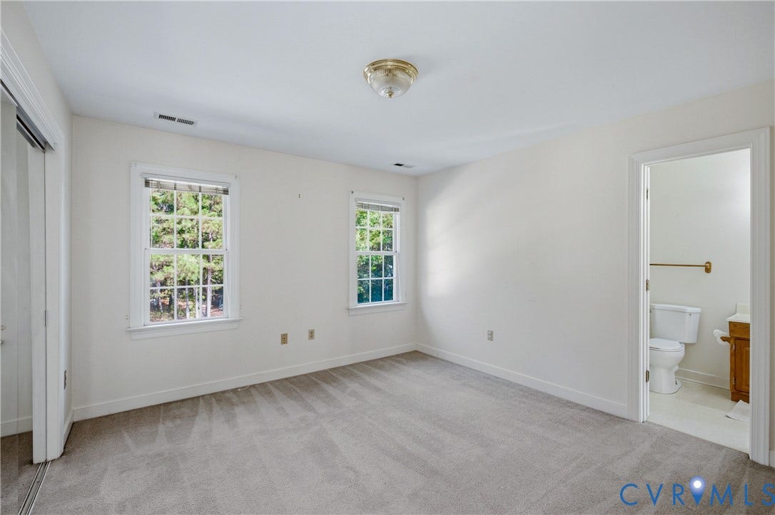 11400 County Drive, Prince George, VA 23842 Neutral-toned interior featuring wall-to-wall carpeting, dual double-hung windows, ceiling-mounted light fixture, and an entry to a jack and jill bathroom
