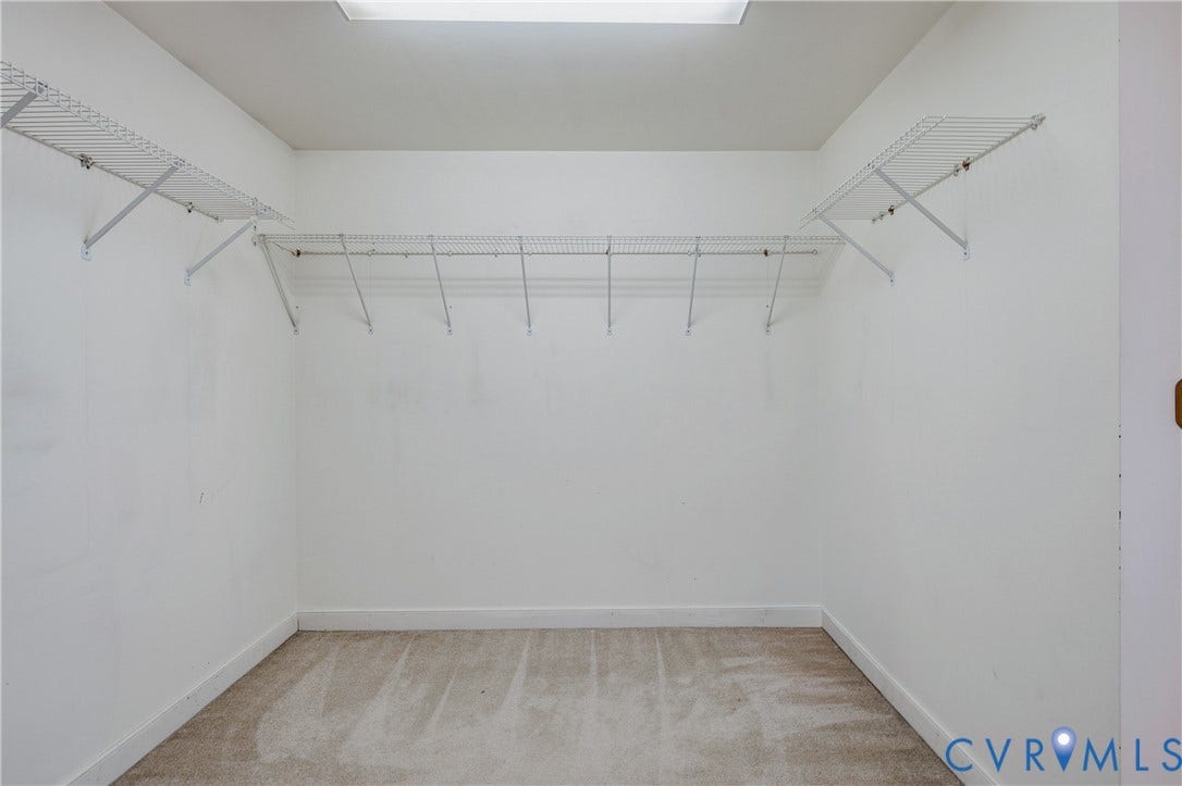 11400 County Drive, Prince George, VA 23842 Primary Walk-in closet featuring neutral carpeting and white walls with tiered wire shelving