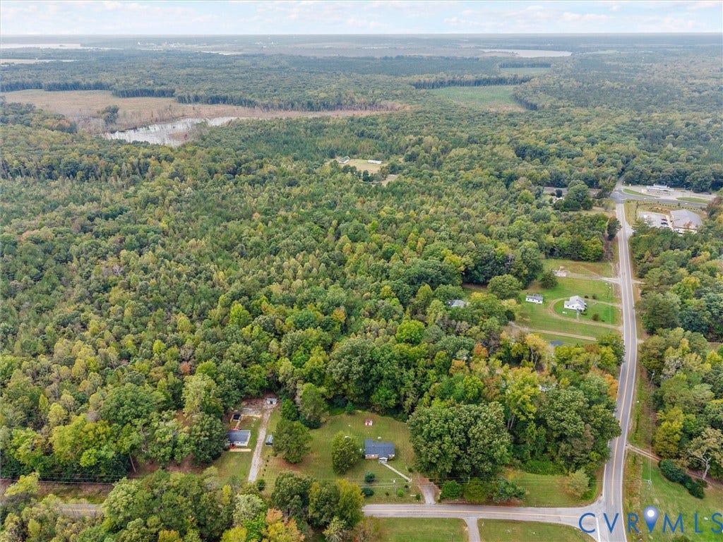 8631 Kimages Road, Charles City, VA 23030 Aerial perspective featuring expansive wooded acreage, mature forest canopy, and direct paved road frontage