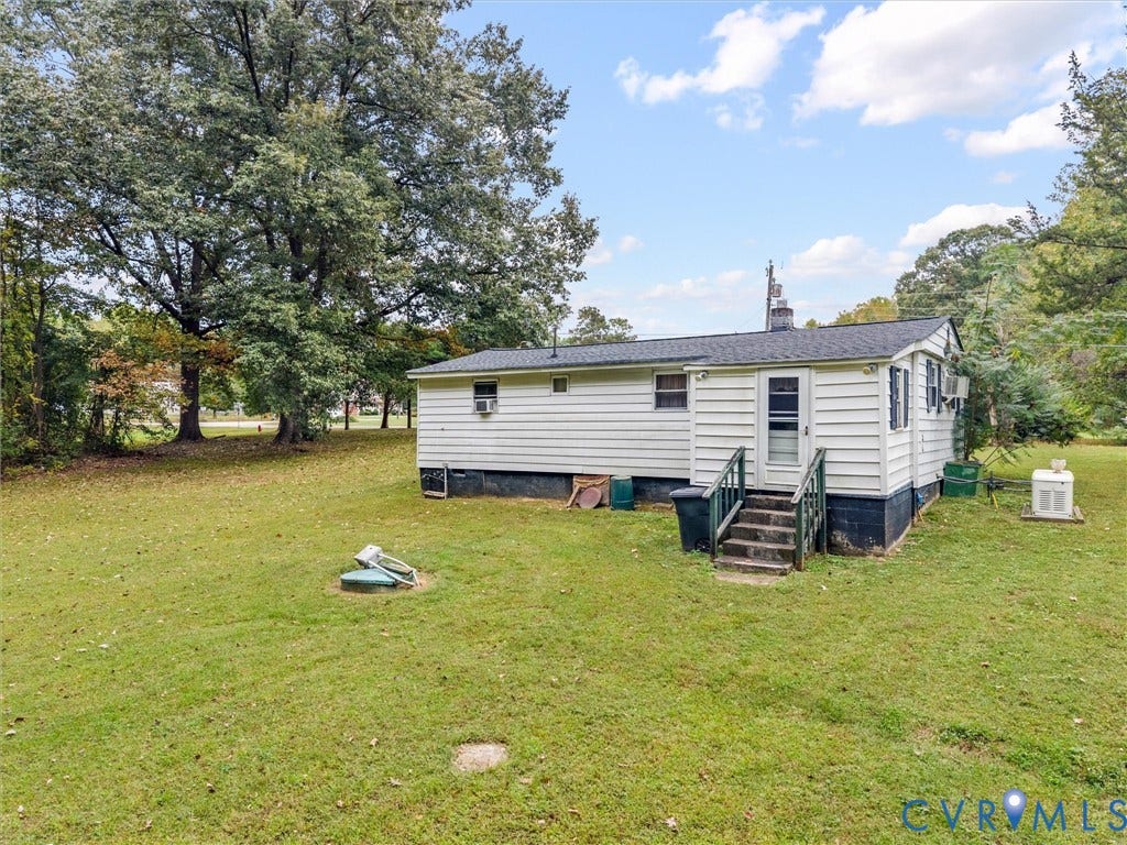 8631 Kimages Road, Charles City, VA 23030 Exterior featuring white horizontal siding, dark-toned foundation, asphalt shingle roof, and wooden stairs with railing