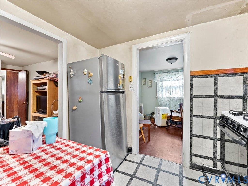 8631 Kimages Road, Charles City, VA 23030 Kitchen featuring a stainless steel refrigerator and tiled backsplash with a grid pattern