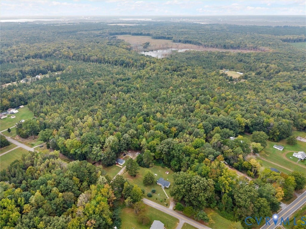 8631 Kimages Road, Charles City, VA 23030 Aerial perspective featuring expansive forested terrain, mature woodland cover, and open grassy areas