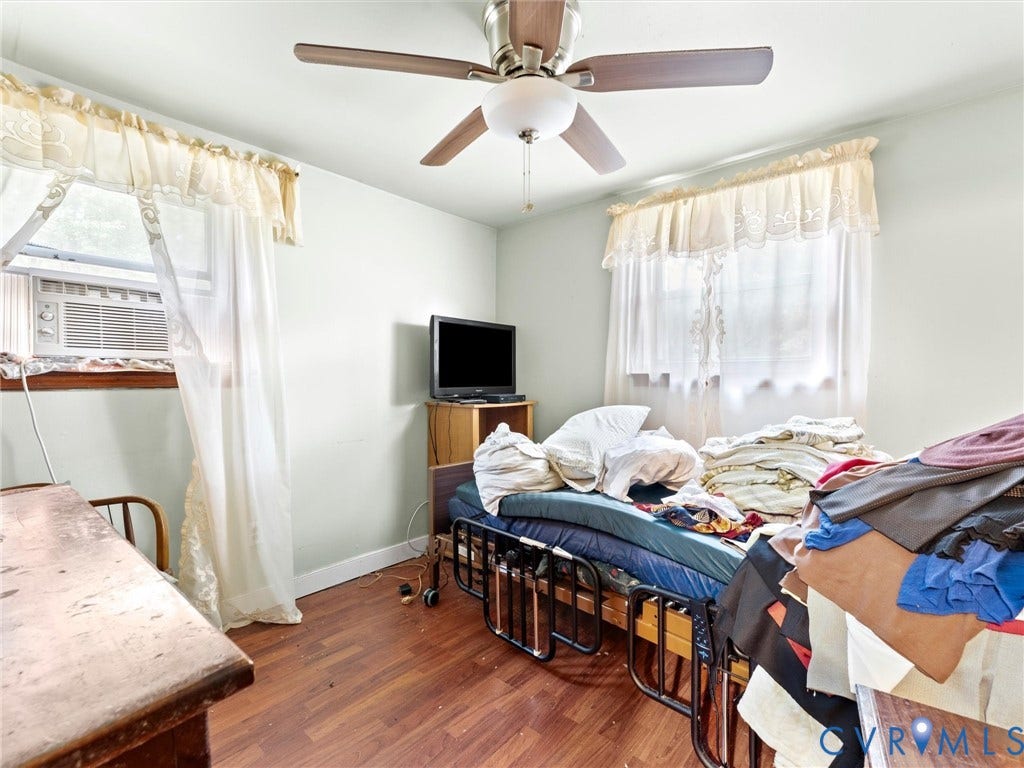 8631 Kimages Road, Charles City, VA 23030 Interior room featuring wood-finish flooring, a ceiling fan with integrated lighting, and dual windows