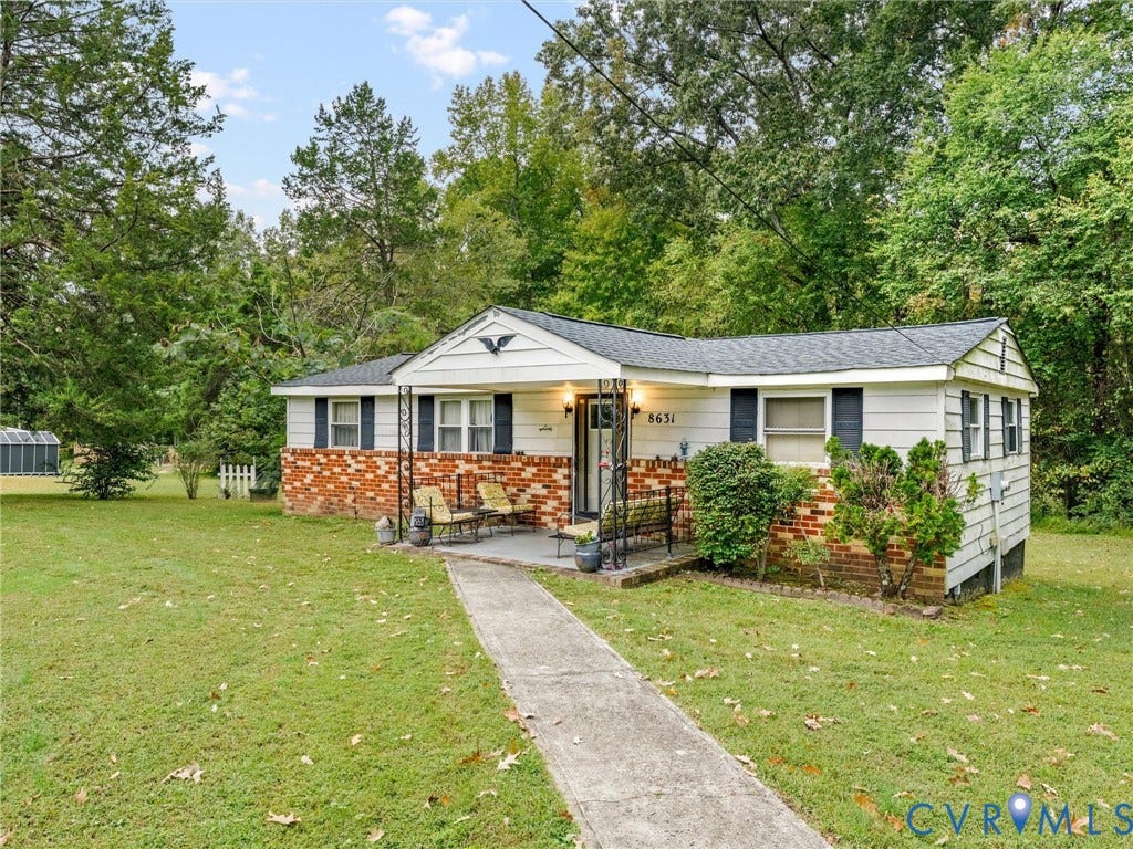 8631 Kimages Road, Charles City, VA 23030 Ranch-style exterior featuring horizontal lap siding, a partial brick facade, a covered front porch with decorative iron columns, and a concrete walkway