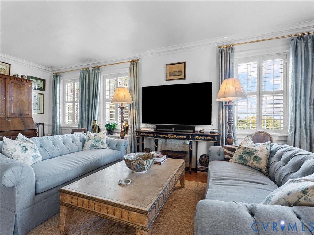 5621 Cary Street Road, #U506, Richmond, VA 23226 Living area featuring crown molding, neutral wall finishes, and plantation shutters