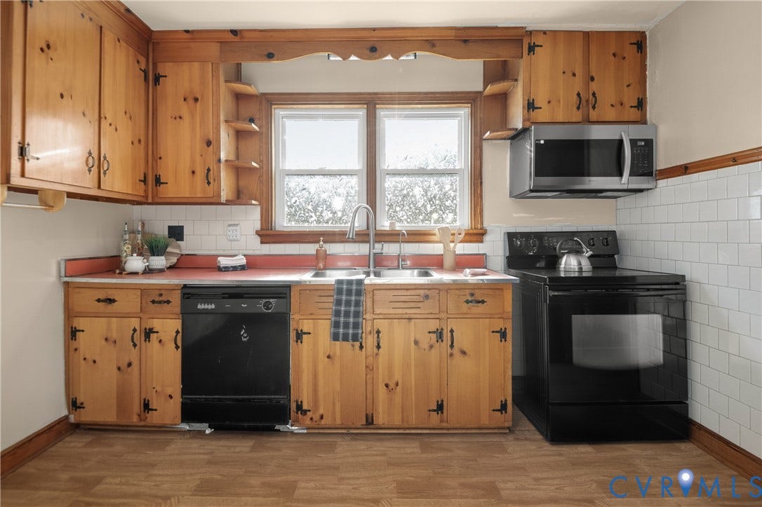 9834 N Wagstaff Circle, Mechanicsville, VA 23236 Kitchen featuring knotty wood cabinetry, white subway tile backsplash, dual-basin stainless steel sink with pull-down faucet, and black built-in appliances