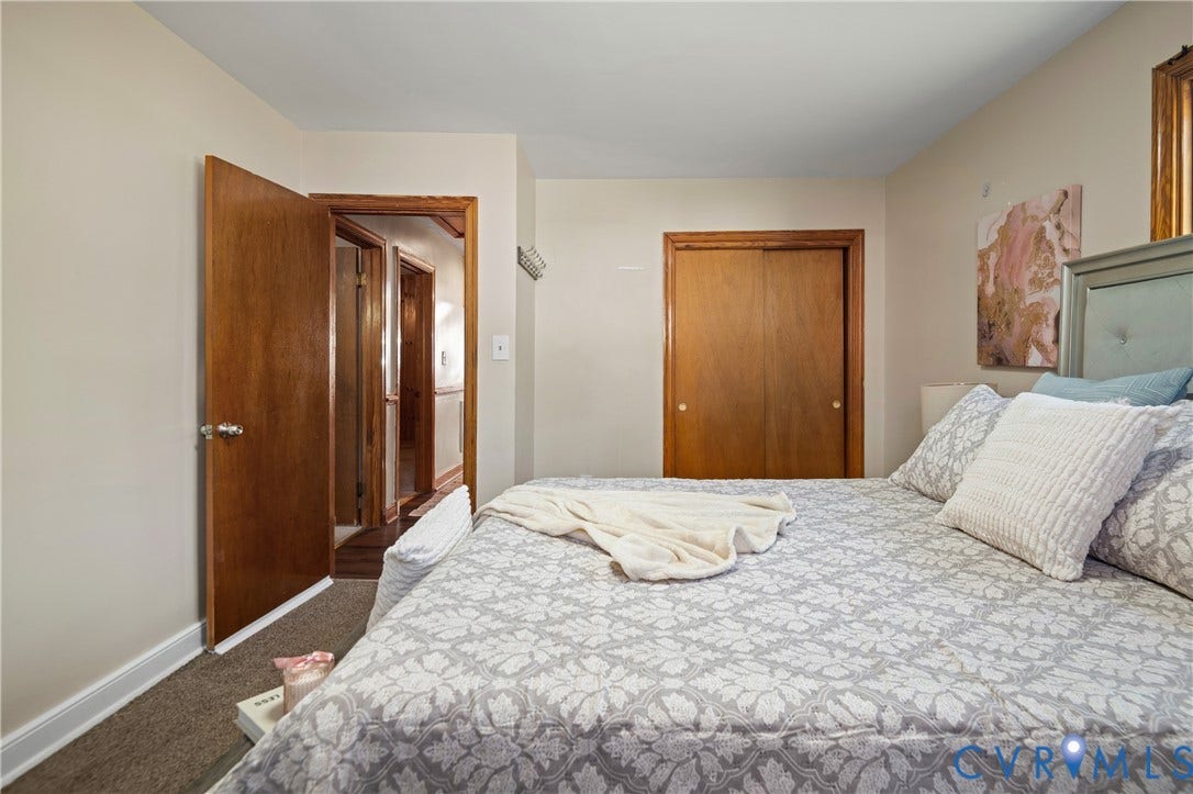 9834 N Wagstaff Circle, Mechanicsville, VA 23236 Room featuring neutral wall tones, wood-finished interior doors, and a double-door closet with wood trim