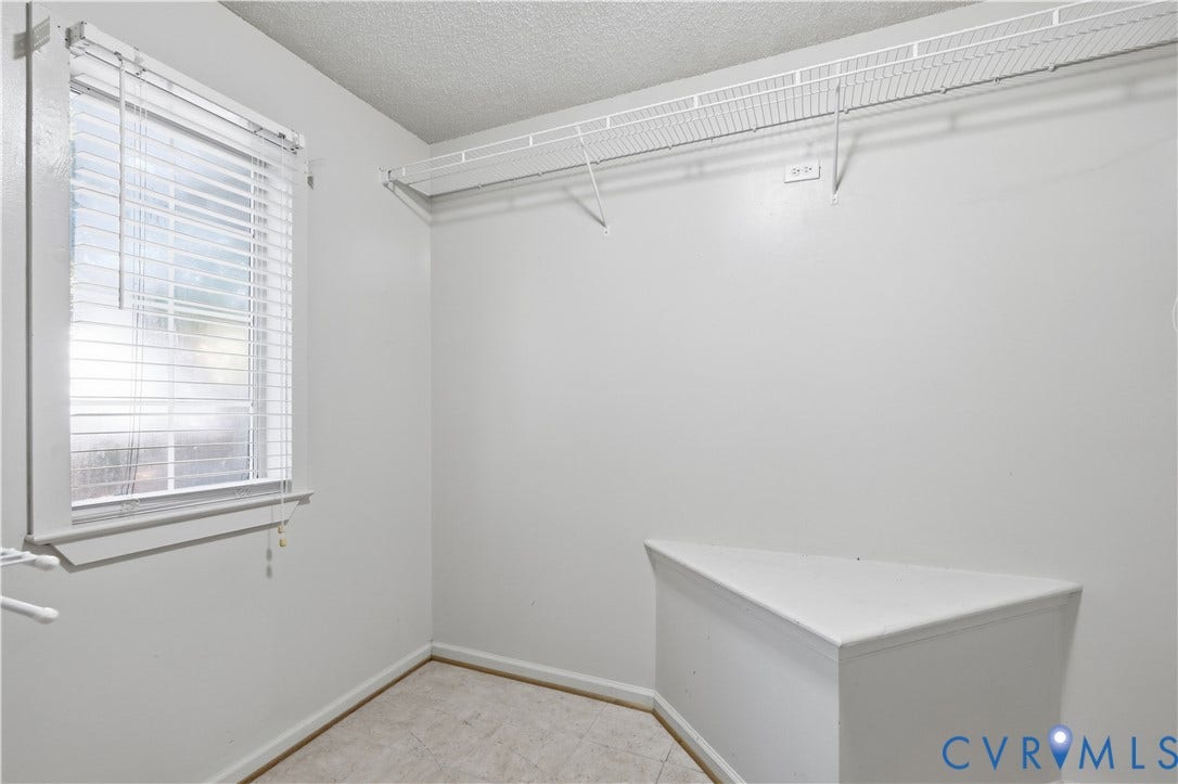 7652 Thacher Drive, Toano, VA 23168 Interior room featuring a window with horizontal blinds, built-in wire shelving, and a triangular built-in platform