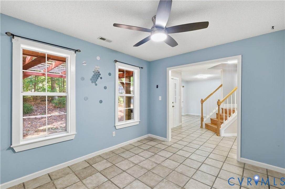 7652 Thacher Drive, Toano, VA 23168 Tile flooring, multi-pane windows, ceiling fan with integrated lighting, and wooden staircase railing