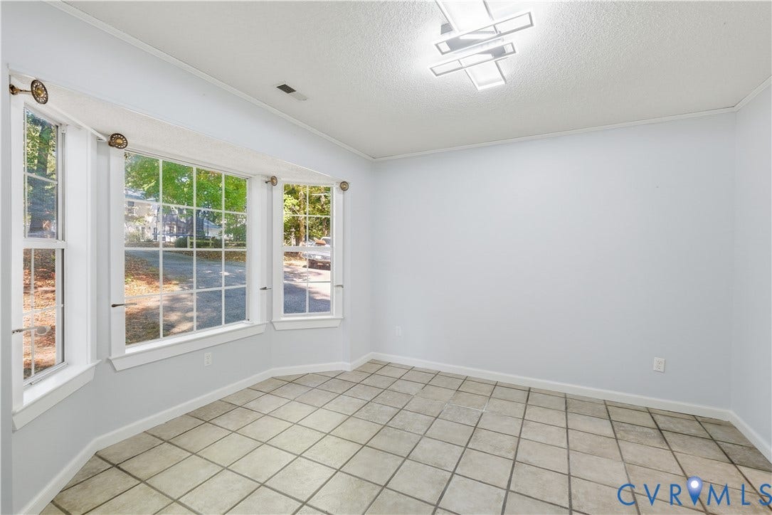 7652 Thacher Drive, Toano, VA 23168 Bay window featuring multi-pane glass, tile flooring, and geometric flush-mount lighting