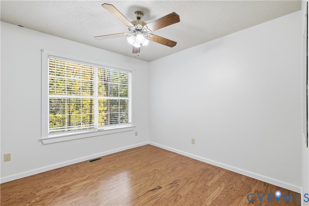 7652 Thacher Drive, Toano, VA 23168 Interior room featuring wood-finish flooring, a multi-pane window, and a ceiling fan with integrated lighting