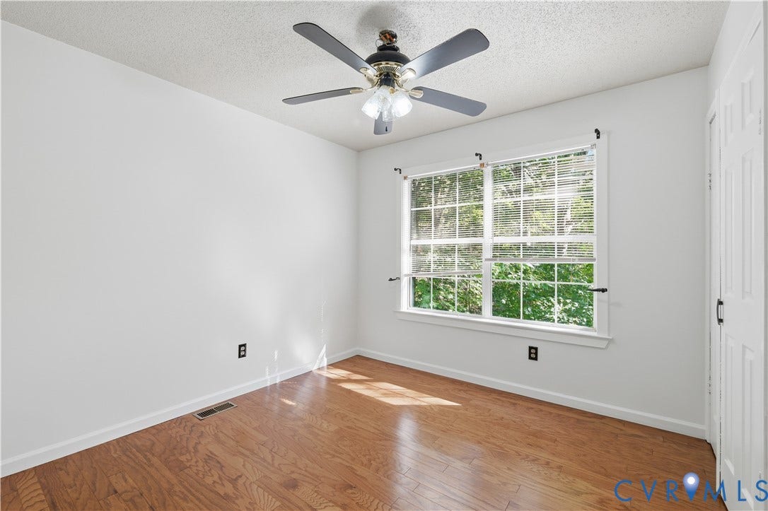 7652 Thacher Drive, Toano, VA 23168 Wood-finish flooring, multi-pane window with blinds, ceiling fan with integrated light fixture, and six-panel interior door