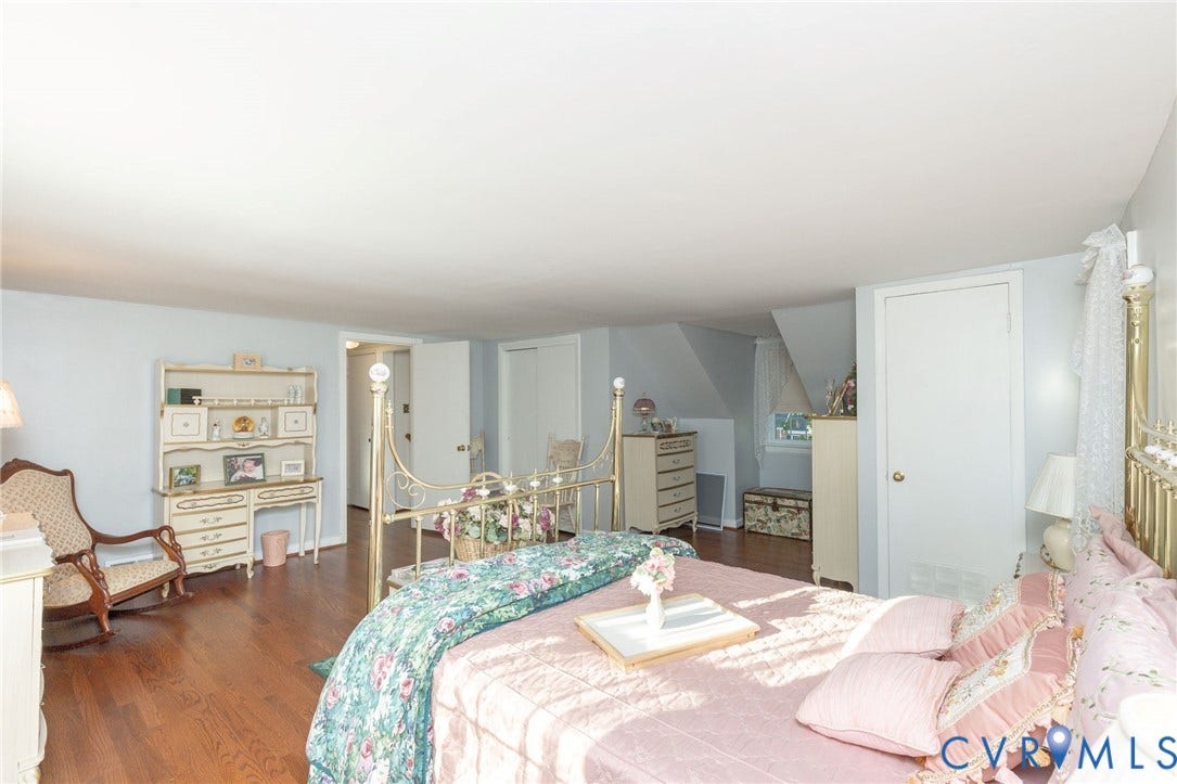 5211 W Grace Street, Richmond, VA 23226 Wood-finish flooring, neutral wall tones, and multiple built-in storage closets