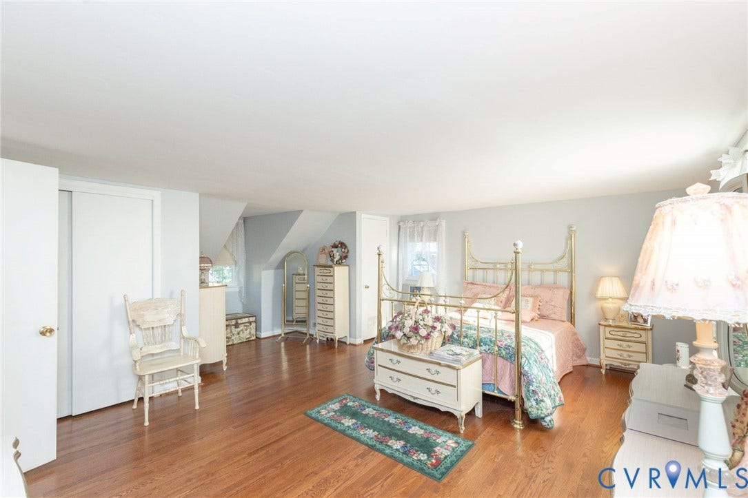 5211 W Grace Street, Richmond, VA 23226 Spacious interior featuring wood-finish flooring, recessed wall nooks, sliding-door closets, and natural light from multiple windows